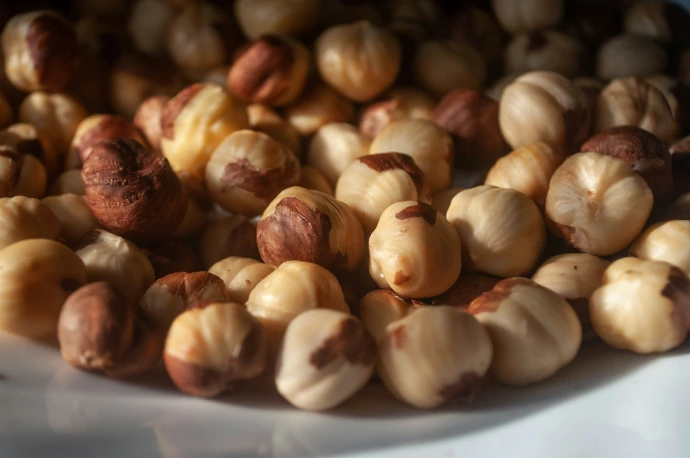 a white plate topped with nuts on top of a table