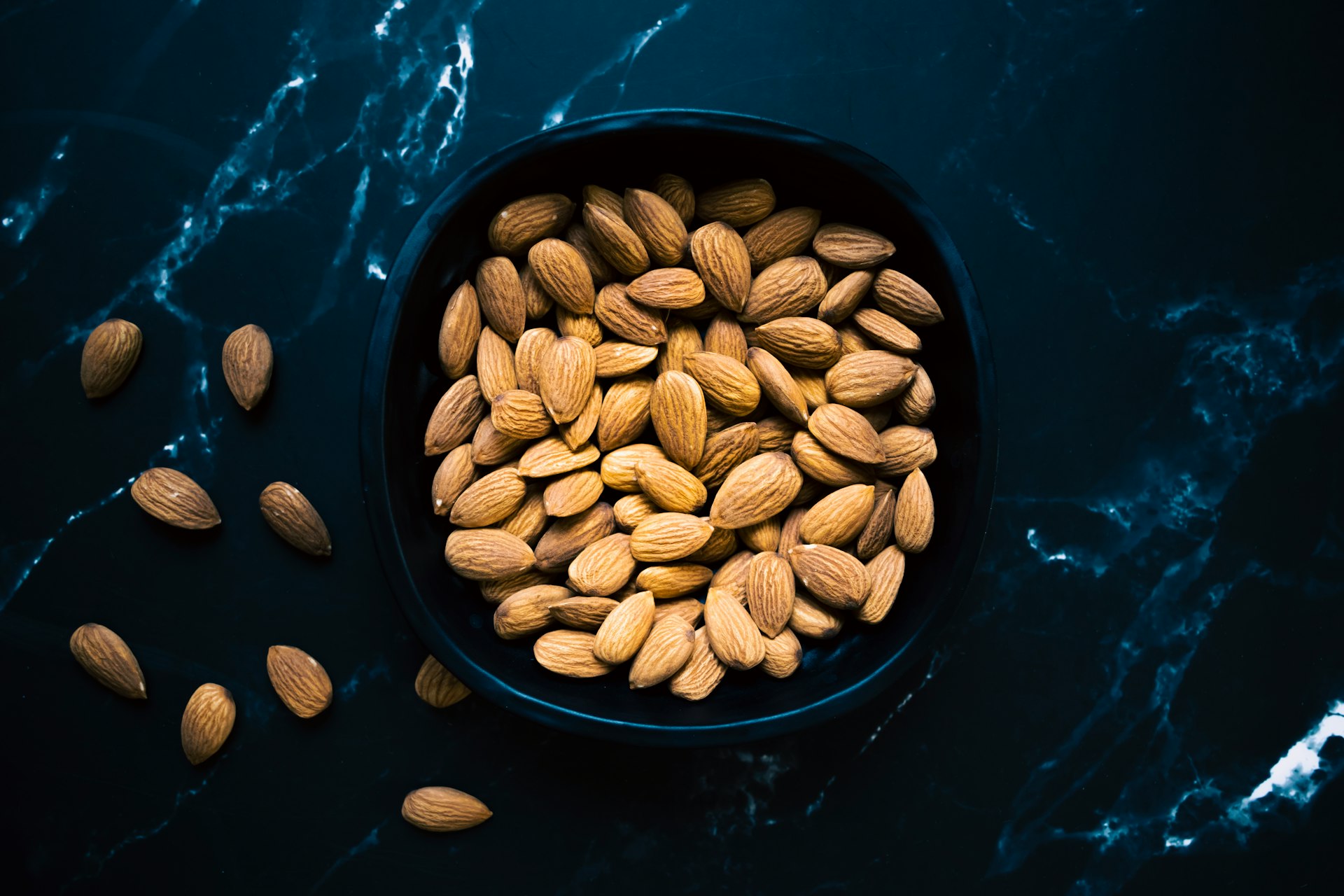 a bowl filled with almonds on top of a table
